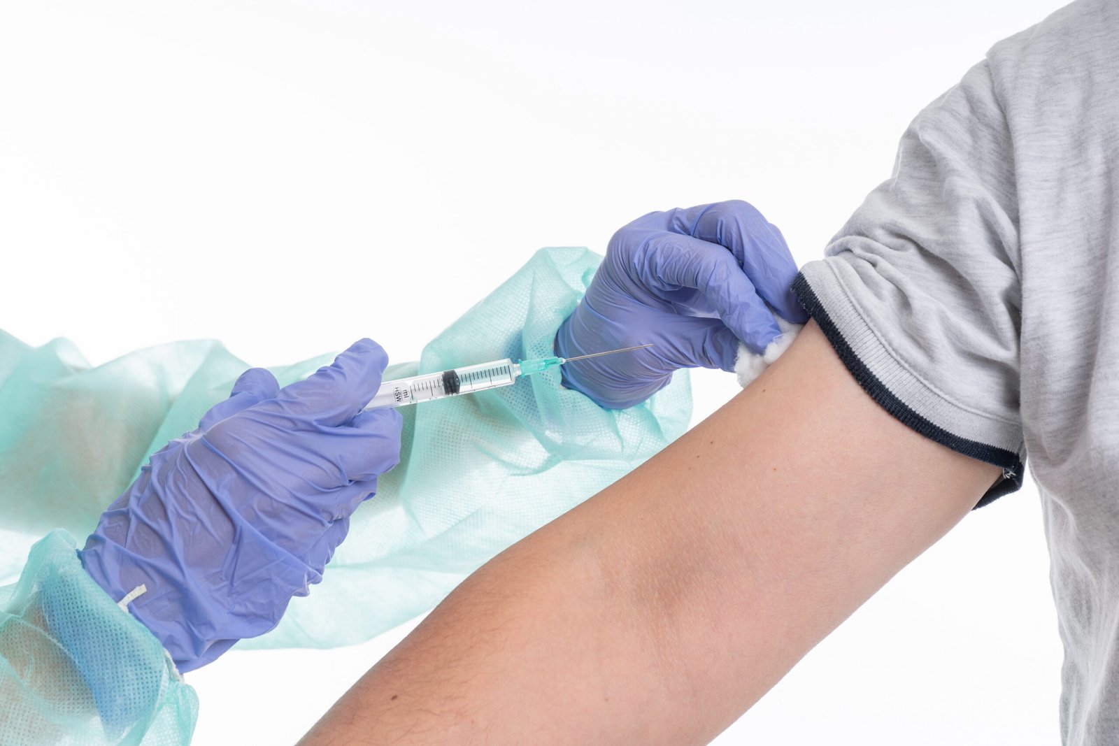 Female doctor with gloves and mask giving Flu Vaccination